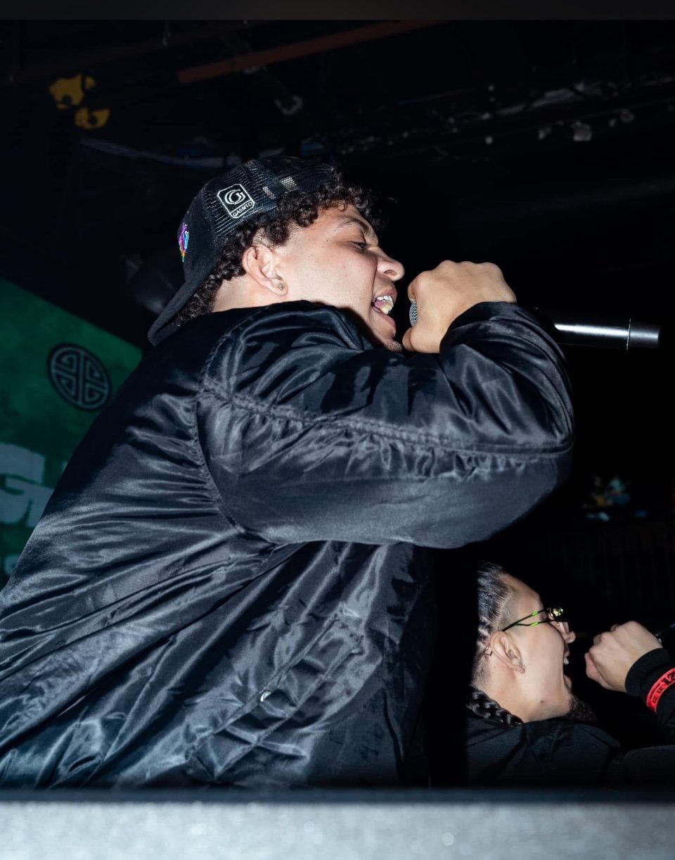Close-up of Rome Rizzo singing into a microphone