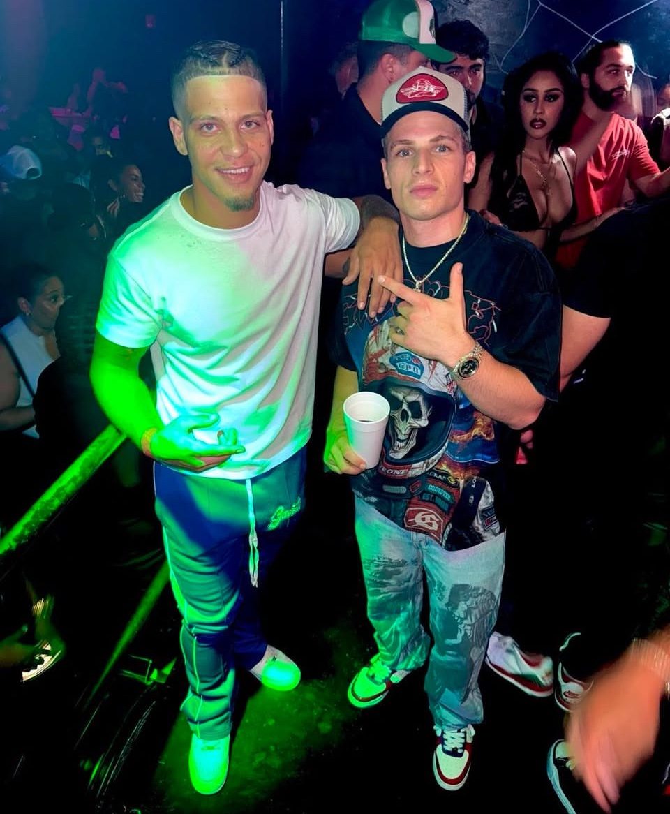 Rome Rizzo posing with a collaborator at a club event