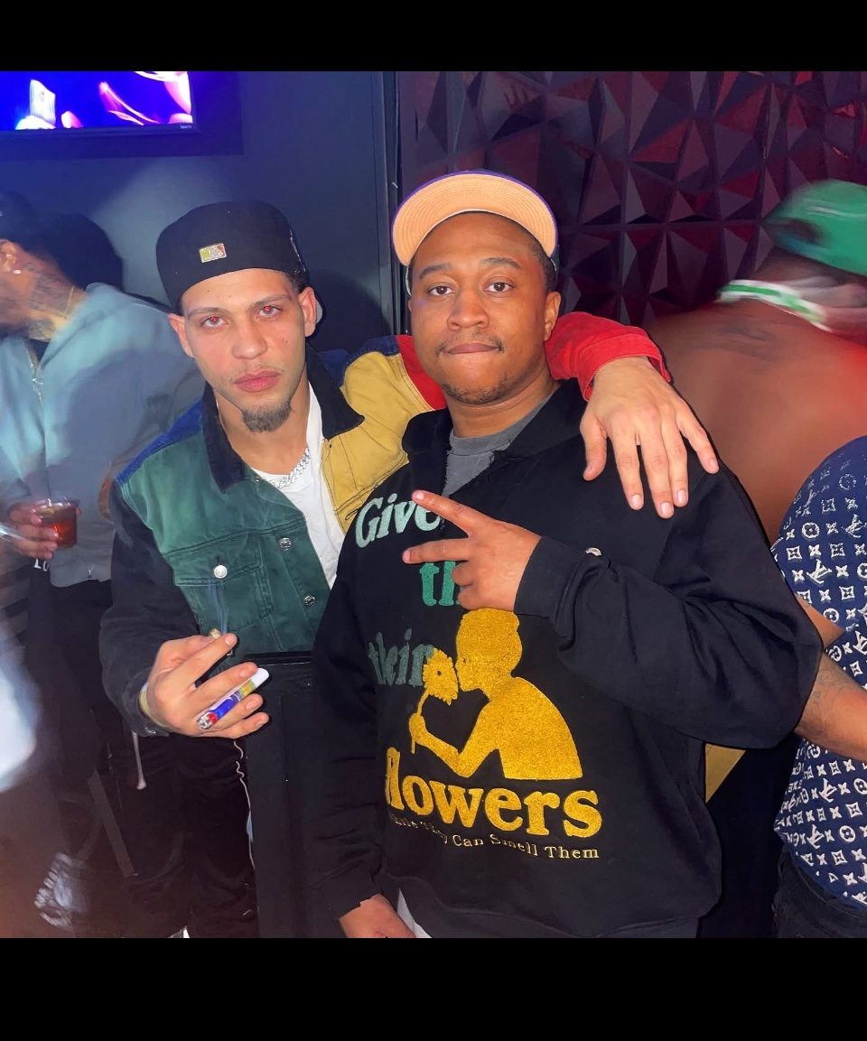 Rome Rizzo with a friend at an event under green lights